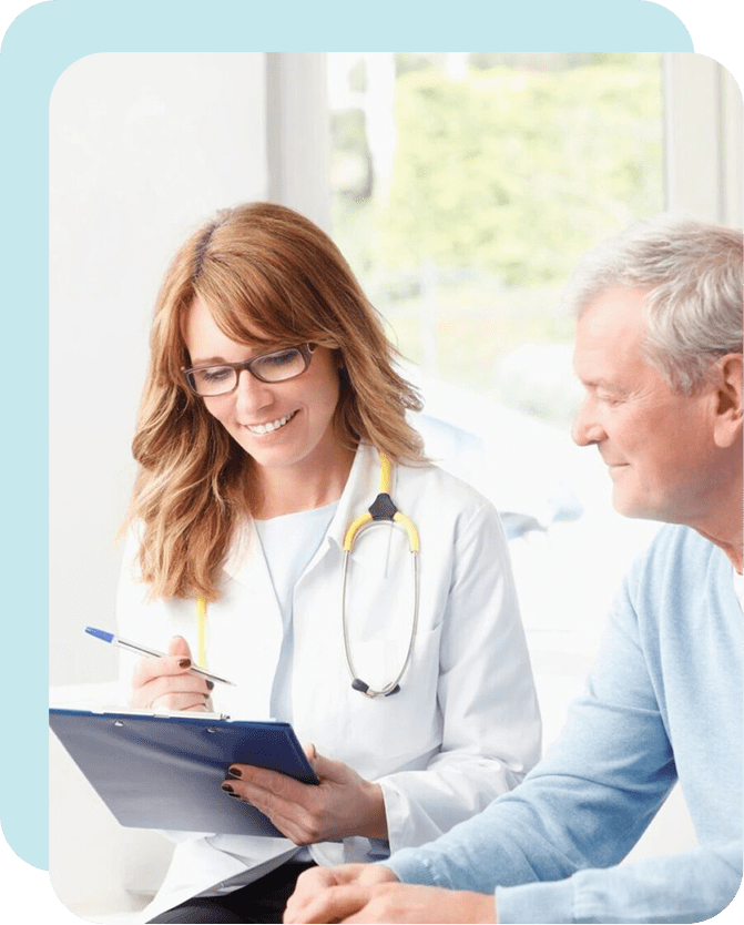 A doctor and patient smiling at each other.